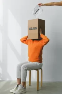 Woman with Box over her head. Hand putting idea in box.